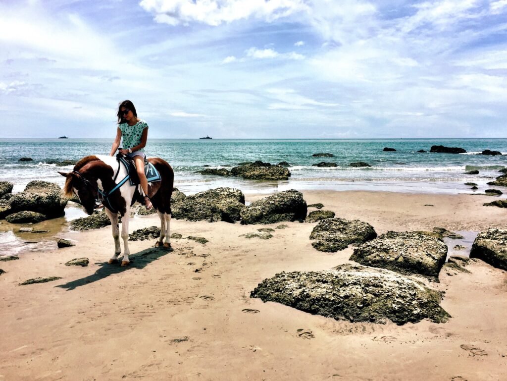 Woman riding a horse at the beach